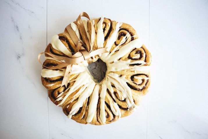 Bring a cinnamon roll wreath as a holiday gift.