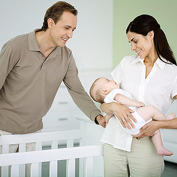 putting sleeping baby into crib