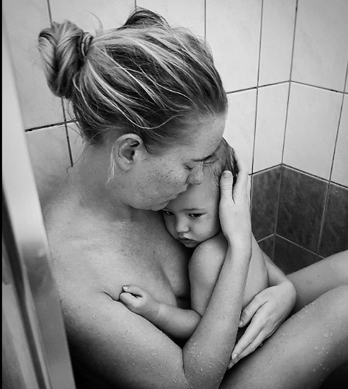 Facebook's Barefoot Mum Kelli Bannister's son took this raw photo of her caring for her sick baby in the shower.