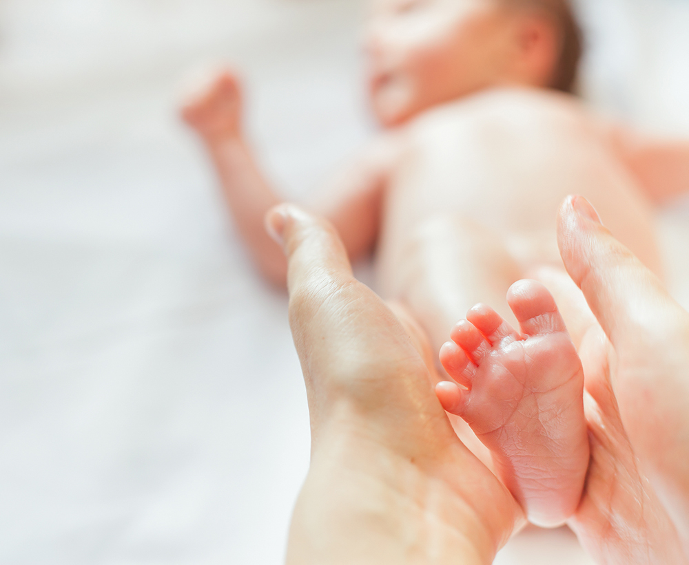 rubbing oil on baby foot