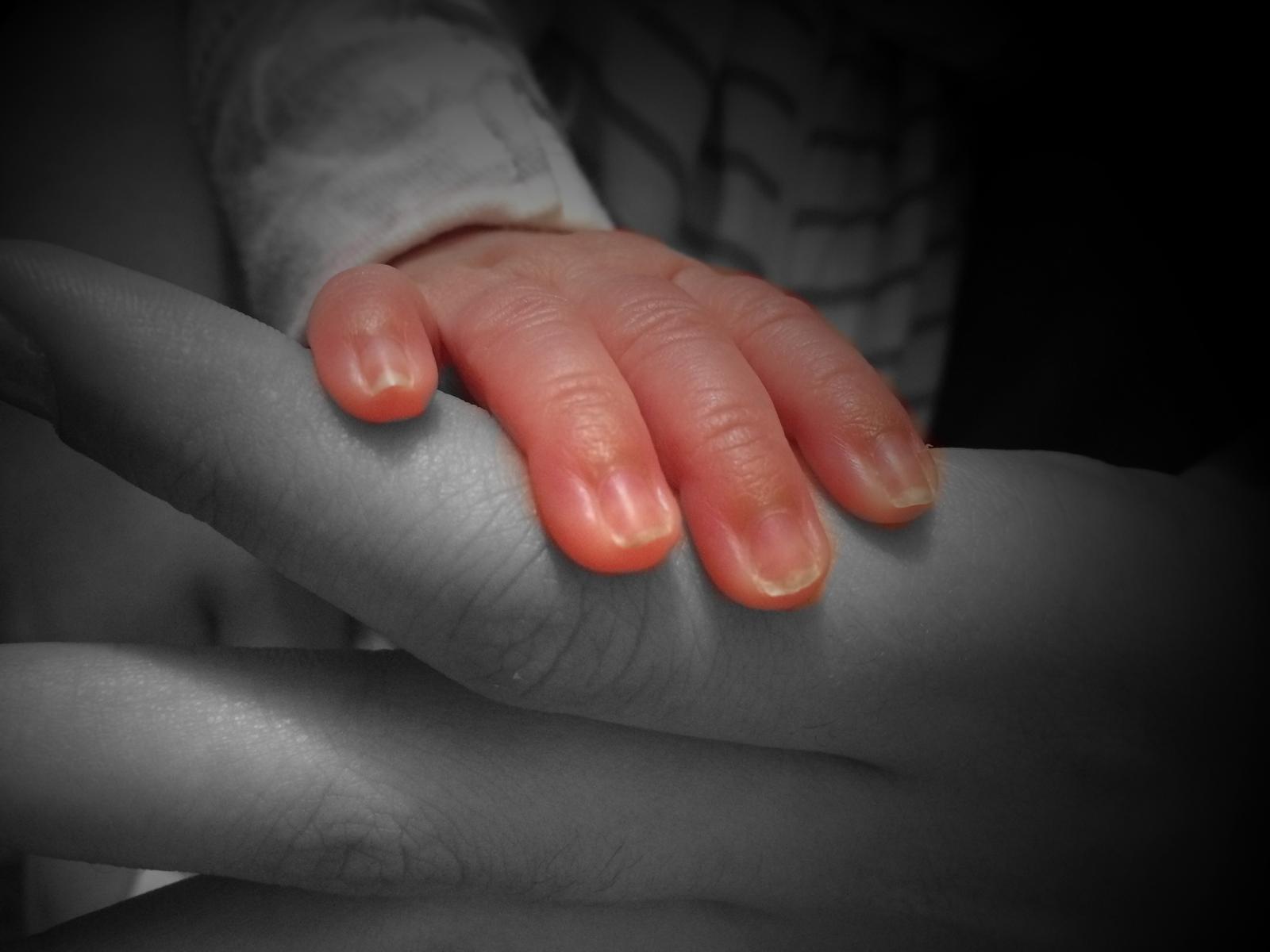 baby hand in color on black and white