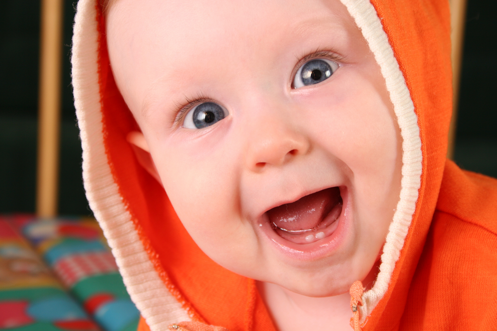 Happy baby in orange hoodie